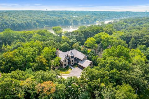 The pinnacle of refined elegance awaits...Tucked amongst towering trees on 3+ acres, this RIVERFRONT estate is the most exclusive hidden treasure that the Fox Valley has to offer. Situated well above the river levee, this sensational home provides un...
