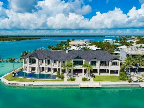 Nestled within the confines of exclusive Plantation Island, at the end of a quiet cul-de-sac, lies a monumental Oceanfront estate of unparalleled proportion. Enveloped in lush tropical landscaping, and sprawling across an oversized 17,900 Sq. Ft. Poi...