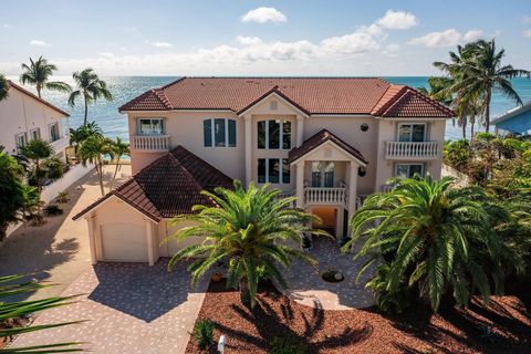 Nestled within the prestigious gated community of Ocean East, this luxurious oceanfront residence is a true gem, offering beautiful water views to the South AND the North! In an exclusive community of 16 homes, this waterfront estate offers an impres...