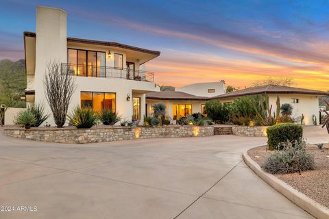 Paradise Valley area homes often present the buyer a tough choice between large, flat, easily accessible lots, with limited view corridors; OR the restrictive access of smaller, hillside lots with dramatic views. This one-of-a-kind architectural mast...