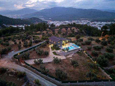 Located in the Bozyer Neighborhood of Fethiye, the favorite tourism center of Muğla, this uniquely designed 4+1 villa offers a peaceful life intertwined with nature. With its modern architecture and wide usage areas, it offers both a comfortable livi...