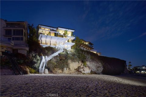 Perched above the sand on Laguna Beach's most sought-after shoreline, this architectural masterpiece offers 79' of beach frontage with breathtaking panoramic ocean and coastline views. Painstakingly rebuilt by renowned interior design firm Aria Desig...