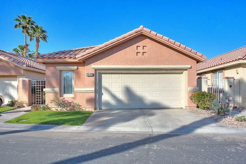 Welcome to 76870 Danith Place at The Oasis Country Club. The private gated entry leads to this charming home with an open-concept floor plan. High ceilings grace the living, dining, and kitchen areas, all warmed by a three-sided fireplace. Double doo...
