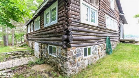 CENTURY LOG HOME ISLAND PARADISE! Ever dreamed of owning your own private island retreat? This cozy century cottage offers a once-in-a-lifetime opportunity to own your own piece of paradise, where beautiful sunsets paint the horizon and create a pict...