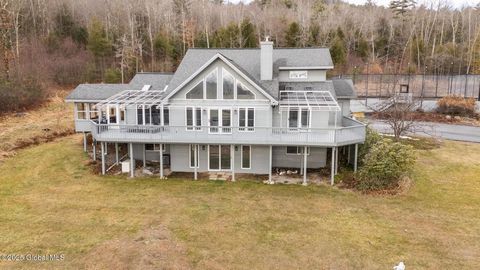 Set on over 6 acres of private land, this contemporary home offers sweeping views of Lake George, providing an ideal setting for both relaxation and recreation. This 5-bedroom, 3.5-bath home offers the perfect balance of luxury, recreation, and natur...