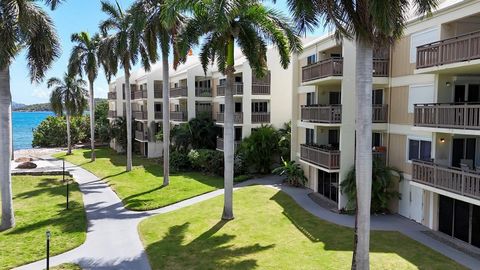 OCEAN VIEWS & BEACH FRONT LIVING - Located in the most sought after building in this condominium community; the AMERICA building is steps from the pristine shore line of Cowpet Bay. With the amenities and lush grounds of a private resort, owners enjo...
