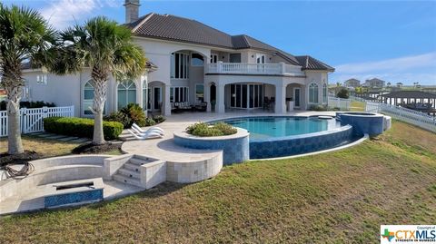 Nestled along the serene shores of Port O'Connor, this magnificent 6,053 square foot waterfront residence offers an unparalleled blend of opulence, comfort, and natural beauty situated on 2 lots with covered boat lift for 2 boats. With its sweeping v...