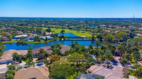 Experience the epitome of luxury in the esteemed Weston Hills Country Club Poinciana, boasting a breathtaking view of the golf course and lake. Situated on an expansive lot exceeding 22,000 sq ft, this home is a masterpiece of elegance and sophistica...