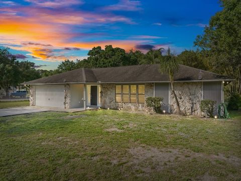 Welcome home! This charming 4-bedroom, 2-bath house is situated on a beautiful 2+acre lot nestled in a quiet country setting. The house exudes warmth and character, perfectly designed for family gatherings. A large pool and screened lanai, a barn wit...
