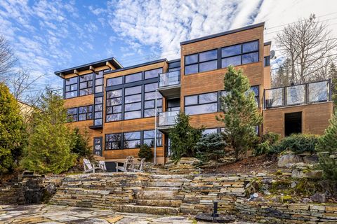 Welcome to 29 Rue des Trembles, a five-bedroom, three-bathroom lakefront home on prestigious Lac Masson in the Laurentians, just an hour from Montreal. Upon entry, floor-to-ceiling windows flood the home with natural light and offer breathtaking pano...