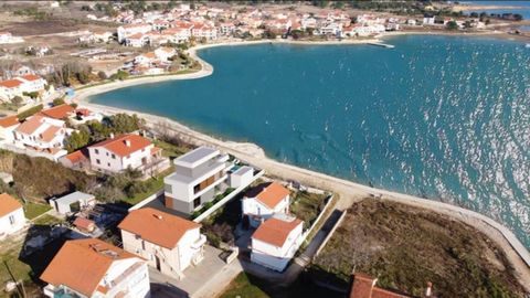 This luxury high-tech villa is located in Dalmatia, in Privlaka, on the first row to the sea! Villa benefits fantastic modern architecture and amazing sea views!  The villa will be finished in a contemporary style at the beginning of 2023, is fully a...