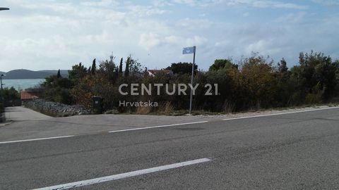 An attractive building plot for sale in Pirovac, Vrulje area.   The land is next to the main road towards Šibenik, 1 cadastral parcel with an area of 8950 m2. It is located in an undeveloped construction area, where it is possible to build residentia...