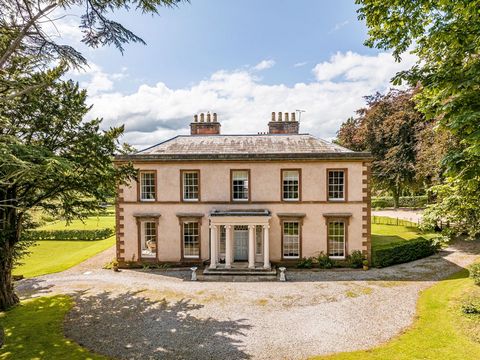 This stunning home is approached by a stone pillared, gated entrance and generous gravel drive. The front façade of the property is impressive with its classic period symmetry and columned portico. The entire property has had a complete replacement o...