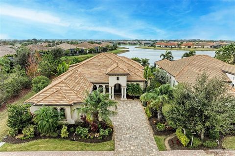 Built with exceptional detail to quality and design, welcome to the Prestbury Neighborhood of Country Club East, Lakewood Ranch. This stunning, one-level residence boasts 3 bedrooms, 3 baths and an expansive 3,425 square feet, offering an abundance o...