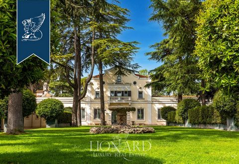 Nestled between Tivoli and Rome, this unique 18th-century estate spanning 7 hectares is for sale. It includes a main house, restored stables, a barn, three cottages, a helipad, and an olive grove. The 2,930-sqm interiors are versatile, suitable for b...