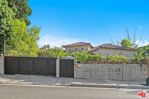 Nestled behind private gates and surrounded by lush landscaping, this updated Spanish blends classic 1920s character with contemporary luxury. The home offers expansive indoor and outdoor living spaces, perfect for entertaining or enjoying quiet priv...