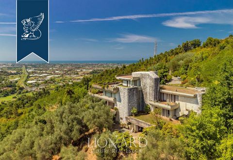 Framed by the majestic Apuan Alps and the renowned Versilian Coast, this spectacular estate for sale was designed by great Florentine architect Paolo Piazzesi. Built in the 1970s on top of a hill overlooking the center of Camaiore, this property is t...