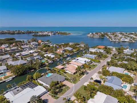 Stunning 3 bed, 3 bath home on deep sailboat water with 103' waterfront in Holmes Beach, FL. Impeccably maintained, featuring an open floor plan, new seawall, dock, mature landscaping, and a beautiful pool/spa. Enjoy the convenience of walking to Ann...
