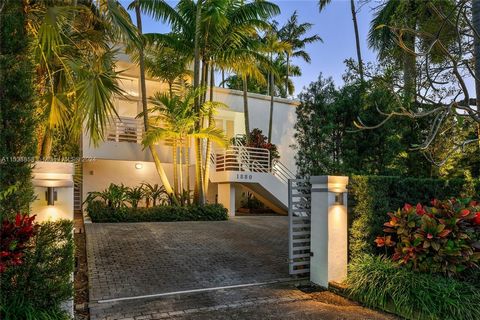 Located in the heart of the much-desired North Coconut Grove this tri-level home sits on a gated, lushly landscaped 9,000 SF lot featuring 5BR/4+1BA. Open dining area w/high ceilings flows seamlessly into a large living room surrounded by windows, & ...