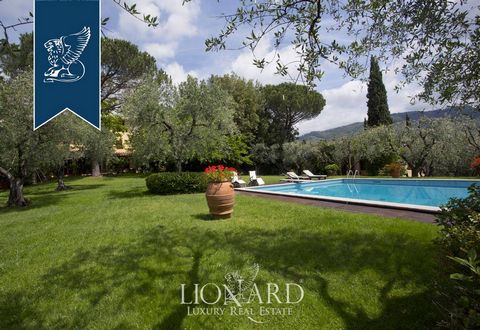 On the hills between Lucca and Pistoia, in Tuscany, this house for sale is surrounded by splendid vineyards and olive groves, entirely fenced, and includes six parking spaces. The estate houses a large park of five hectares with ancient curbs and san...