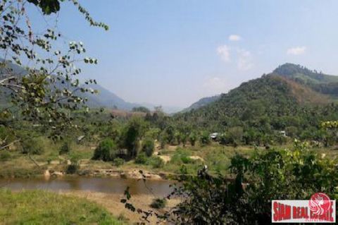 This is a nice land plot with 3 rai of palm plantation in the front. The back portion of the land has a river view and next to a bridge. The river flows through the land. The size of the plot is 11 rai and 3 ngan (11-3-0). There is a gravel road acce...