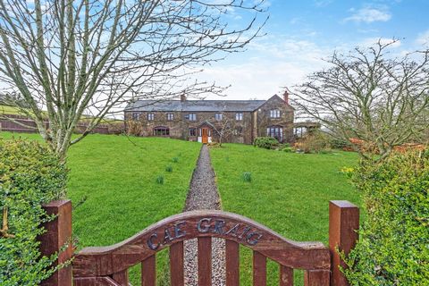 Nestled within 35 acres of its own land that includes woodland, paddocks and views, this charming four-bed cottage called Cae Graig is full of character and light that wraps you up in a welcoming ambience within its spaces to create lifelong happy me...