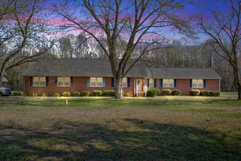 Don't miss this exceptional opportunity to own a sprawling acreage parcel paired with a custom home! Tucked away down a winding driveway, this 3-bedroom brick ranch offers unparalleled privacy, tranquility, and seclusion. Also a hard-wired generator ...