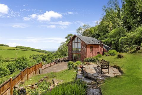 A rare opportunity to acquire a recently built detached country Cottage within The Exmoor National Park set in delightful hillside gardens with woodland amounting to over 10 acres in all. The property is located off a bridleway in a wonderful rural l...