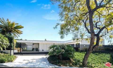 Discover this ultimate hillside oasis located in prime Trousdale Estates with spectacular city and ocean views. Completely redesigned by renowned contractor Gordon Gibson, this fabulous Contemporary estate delivers clean lines with walls of glass and...