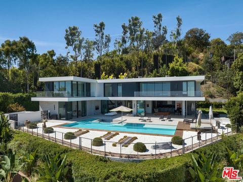 Back on the market and move in ready! Situated in the heart of Beverly Hills, this extraordinary modern estate is thoughtfully crafted to blur the lines between indoor and outdoor living. The grand two-story entrance, featuring an indoor koi pond, ex...