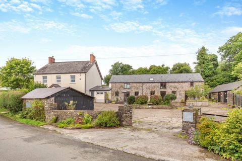 Main House Facing is the converted barn that provides the holiday cottages whilst the main house sits off to the left behind a low hedgerow and a picket gate begins the journey to the front door, although a wrought iron gate takes you in under an arc...