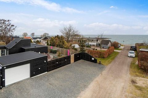 Holiday home with outdoor whirlpool located by Ajstrup beach only 100 approx. meters from a lovely sandy beach. The cottage's kitchen is in open connection with the living room, so here everyone can have fun and play games or cook. The cottage has a ...