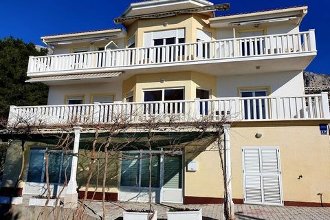 This spacious holiday home is situated on a quiet hillside on the Omis Riviera. From the terrace and the balconies you have a wonderful view of the sea. In the garden, an open grill and patio invites you to spend mild summer evenings. The house can a...