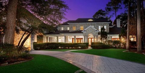 Exquisite custom home overlooking the 2nd Fairway of the Jack Nicklaus Golf Course in 24 hour guard gated Carlton Woods! Located on a 1.47 acre lot with a serene pond in front and golf course views in back, this home offers a stunning Austin stone ex...