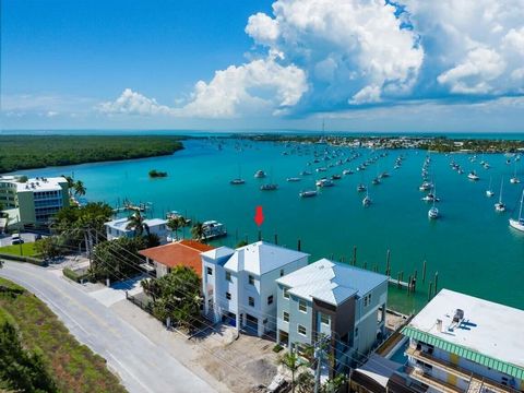 Brand New 2024 CBS Construction with gorgeous Boot Key Harbor Views and excellent boating! Every detail has been considered in this turnkey pool home, boasting high-end finishes, and offering elevated Keys living in a prime location! Upon entry, the ...