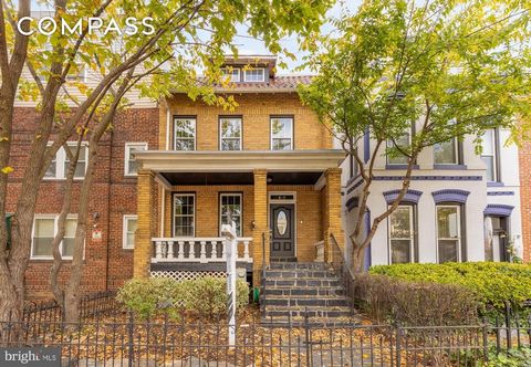 New price! Experience the charm and character of this expansive 2,200 sq. ft. porch-front rowhome on a 2,000 sq. ft. lot, featuring the added convenience of secure parking for two cars with a commercial-grade roll-up garage door. Perfectly positioned...