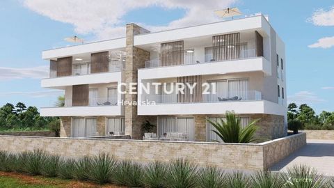 PRIVLAKA-ZADAR SURROUNDINGS- 3-ROOM APARTMENT ON THE GROUND FLOOR, 85M TO THE SEA, SEA VIEW   Selling a beautiful apartment under construction, only 85 meters from the sea. The apartment is located on the ground floor and has its own garden. The apar...