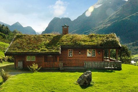 A fine, quality cottage with solid, Norwegian wooden furniture, situated on a hilltop with the most stunning and magnificent view you can imagine! When sitting on the terrace or in the living room, you have a full overview of Nordfjorden and Olden. E...
