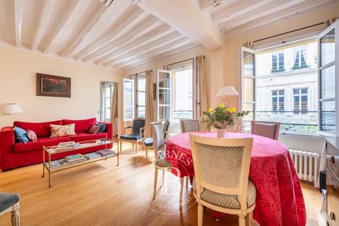 Stunning duplex apartment with the feel of a house, offering 110.89m² (1,194 sq ft) of floor space and opening onto a magnificent ceremonial courtyard planted with trees in a magnificent townhouse steeped in history, with a concierge, on Quai Béthune...