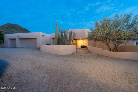 Welcome Home! Beautiful custom home situated on over 1 acre within walking distance of the McDowell Mountains. Breathtaking panoramic mountain views from the home's interior and exterior as well as the rooftop view deck. Built in 1992 by architect/bu...