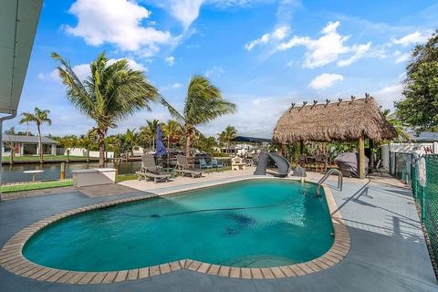Experience epitome of waterfront living in St. Lucie Village with this exceptional property. This charming CBS pool home located on a quiet, dead-end street, & offers tranquility & privacy. Situated on a double lot, this property presents ample outdo...