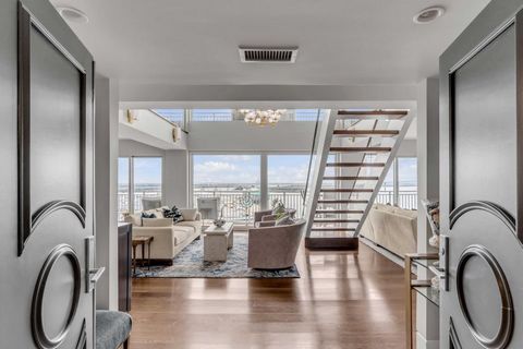 Two level penthouse unit with wide northern views of the Cooper River and Ravenel Bridge. Unit has been intelligently renovated with transitional design elements and to take full advantage of the views from every room. The sleek kitchen features Cala...
