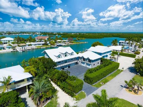 Nestled within the coveted Coco Plum neighborhood, this remarkable estate epitomizes luxury waterfront living in the heart of the Florida Keys. Meticulously crafted by D'asign Source, this custom home boasts an unparalleled blend of sophistication, c...