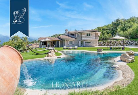 A luxurious modern villa is presented for sale, just a few steps from the Brescia shores of Lake Garda. The villa has a huge territory of one hectare and provides exclusive amenities that include a helicopter zone, a spa center with a biobasin, hydro...