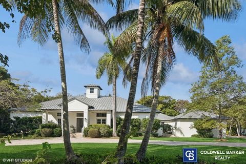 Beautiful sprawling Key West Style gated estate with light, bright, open interiors! Foyer leads to a formal living room with volume ceilings overlooking the gorgeous lushly landscaped yard. Fabulous gourmet kitchen with a breakfast room opens to an i...