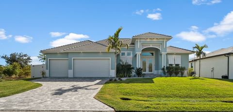 Walk in the front door and let this waterfront home capture you with the gorgeous high ceilings, and open, cool design. Enjoy panoramic views of the pool, lanai and docks. Stunning waterfront luxury! Extra touches appear outside: gas firepits, a casc...