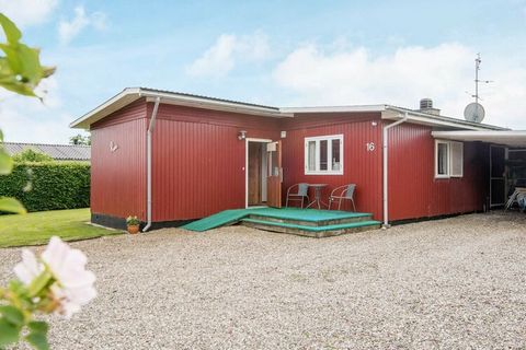 Holiday home by Flovt Strand with conservatory and both open and covered terrace. Living room with wood burning stove and open connection to the kitchen. There is a room with a double bed and a room with a bunk bed. In addition, there is a large anne...