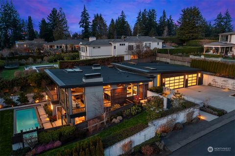 Sited at the apex of Clyde Hill, this remarkable NW contemporary residence is enveloped in privacy and lush landscaping, making a striking impression. Crafted by Baylis Architects and constructed by Gayteway Custom Homes, it presents a seamless fusio...