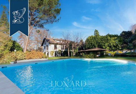 This stunning luxury villa with an outbuilding for sale is along the shores of the river Ticino, in the province of Novara. This property was built in the 1970s and features spacious rooms with high ceilings and high-quality materials, including wond...