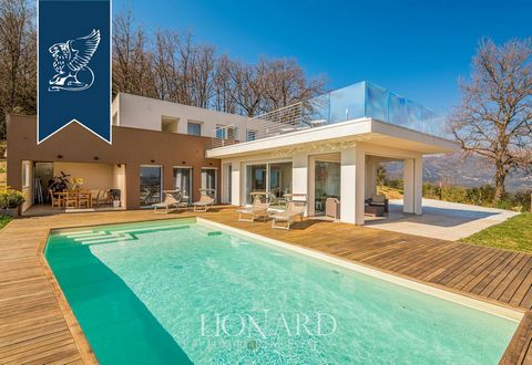 This luxurious modern villa with a pool is for sale by the sea of the Versilia area, in a charming hilly position in Massarosa, not far from Lucca's town centre. Located in a quiet and very leafy residential area, this splendid property was comp...